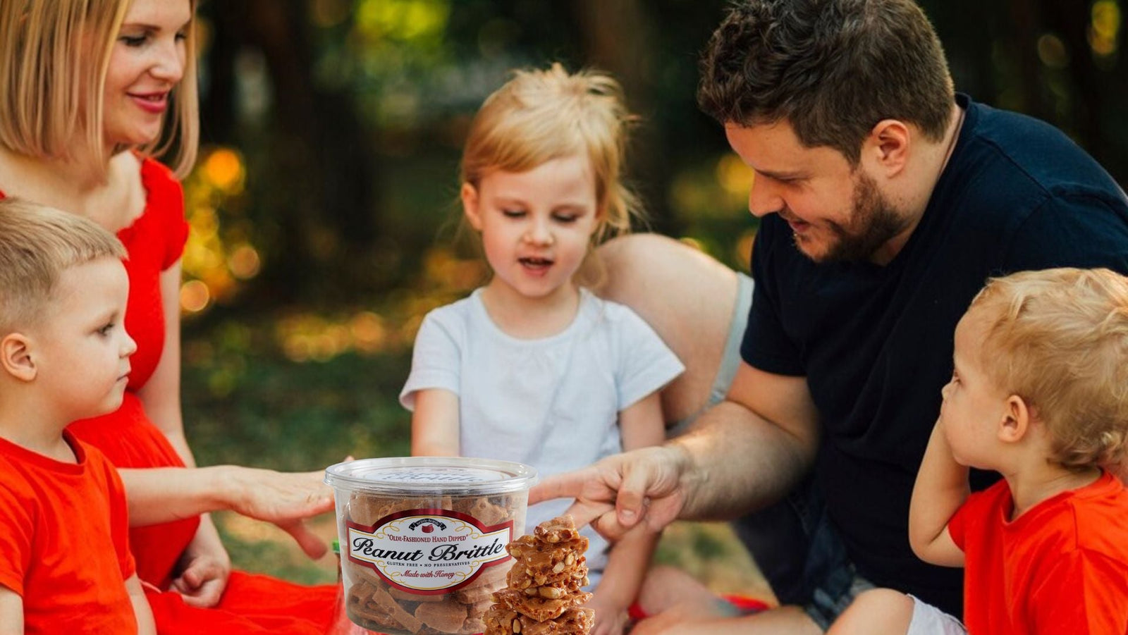 A family enjoying a picnic that includes Brittle-Brittle Gourmet Peanut Brittle