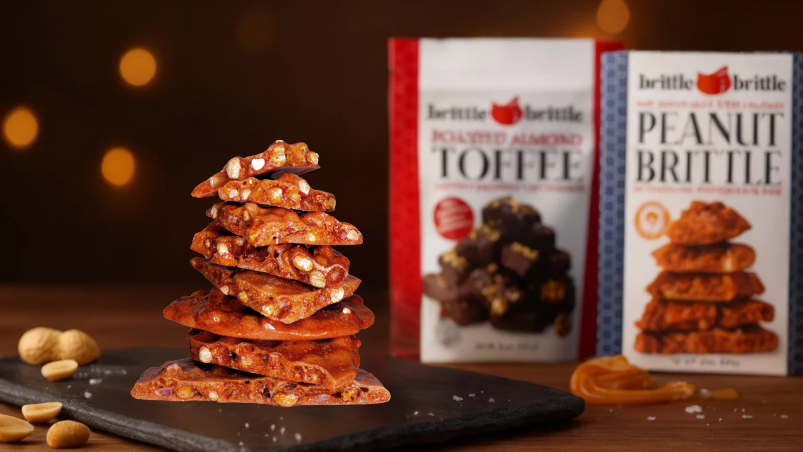 Stack of Gourmet Peanut Brittle in front of Packaging of Toffee and Peanut Brittle.